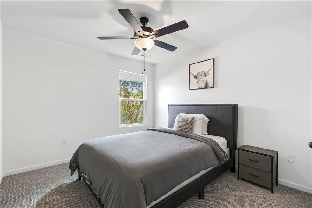 973 Mayson Turner Road Northwest Atlanta, GA 30314 - Photo 18 of 38 a bedroom with a bed and a ceiling fan