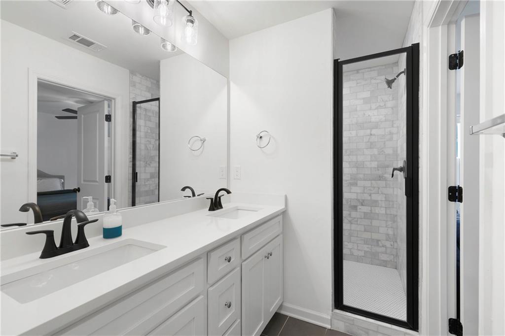 973 Mayson Turner Road Northwest Atlanta, GA 30314 - Photo 24 of 38 a bathroom with a double vanity sink and mirror