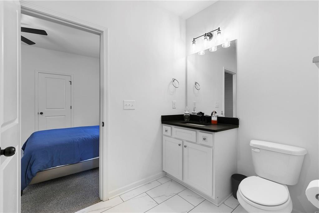 973 Mayson Turner Road Northwest Atlanta, GA 30314 - Photo 29 of 38 a bathroom with a sink a toilet and a mirror