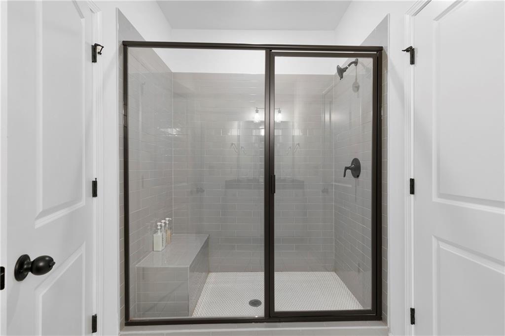 973 Mayson Turner Road Northwest Atlanta, GA 30314 - Photo 30 of 38 a bathroom with a glass shower door