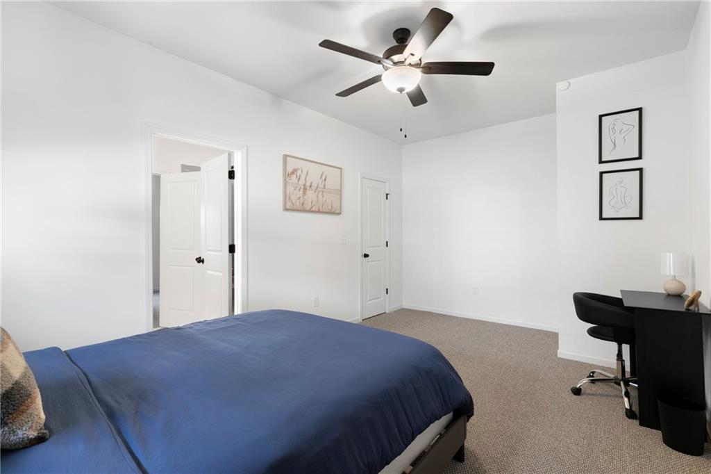 973 Mayson Turner Road Northwest Atlanta, GA 30314 - Photo 31 of 38 a bedroom with a bed and a desk