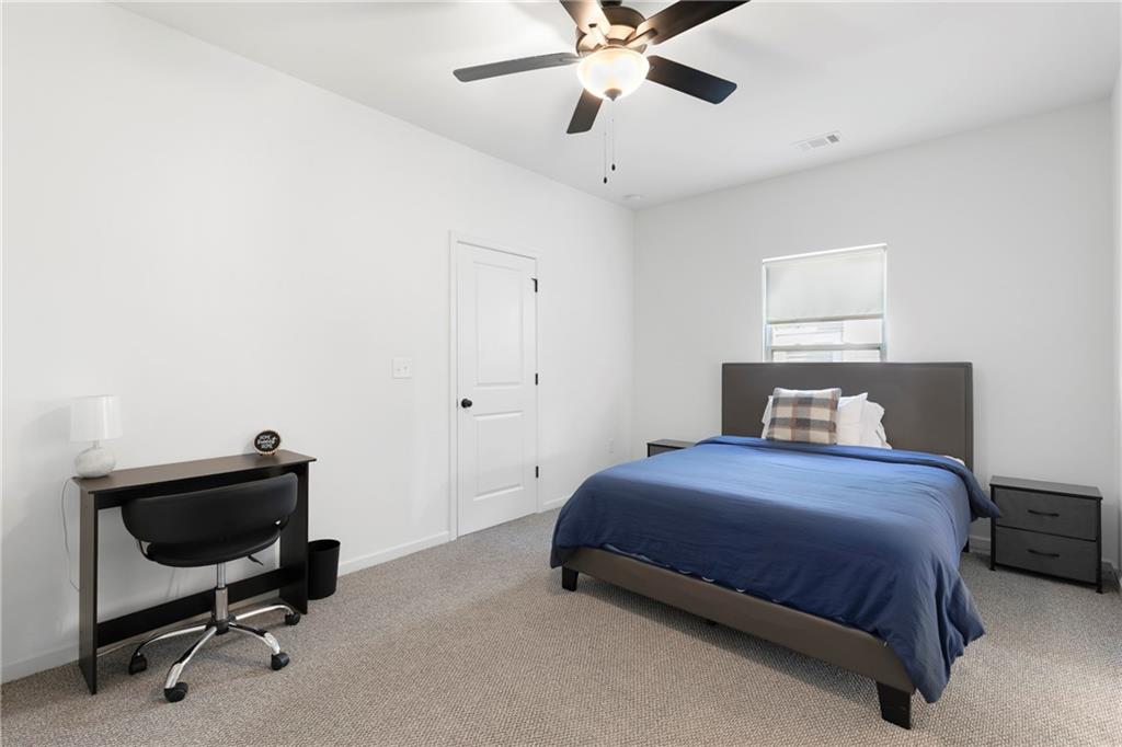 973 Mayson Turner Road Northwest Atlanta, GA 30314 - Photo 32 of 38 a bedroom with a bed and a chandelier