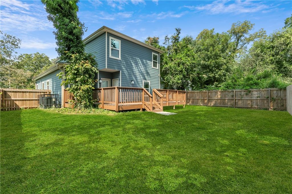 973 Mayson Turner Road Northwest Atlanta, GA 30314 - Photo 34 of 38 a view of a house with backyard and a tree