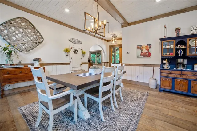 a living room with furniture and paintings on the wall