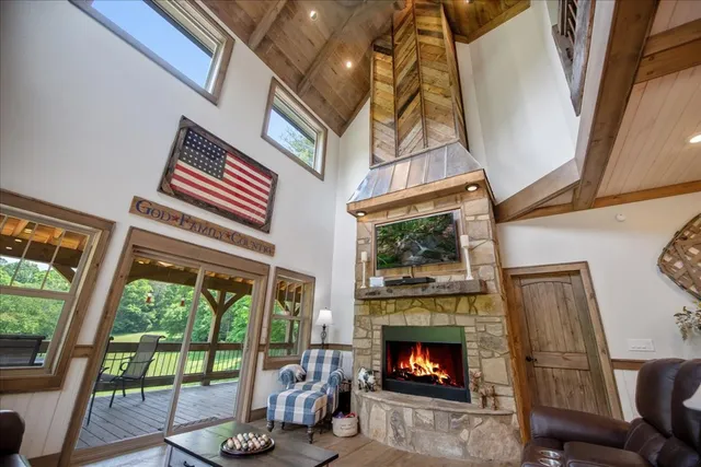 a living room with furniture a large window and a rug