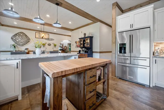 a kitchen with stainless steel appliances granite countertop a sink stove and cabinets
