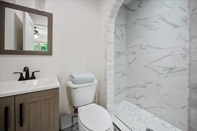 a view of a backyard with table and chairs with wooden fence
