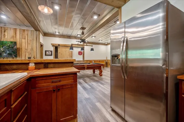 a front view of a house with a garden and lake view