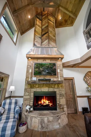 a view of a house with a yard and large trees