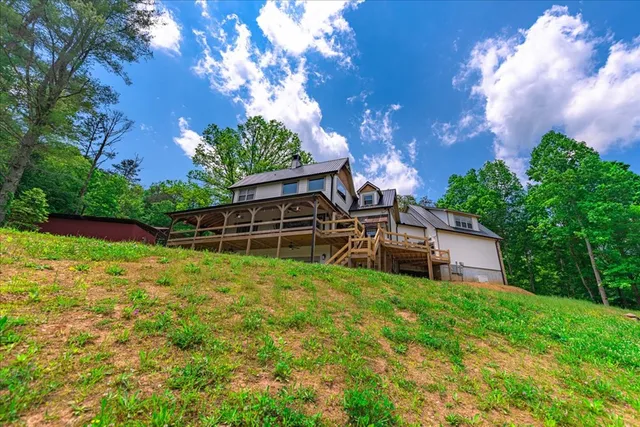 a front view of a house with a yard covered with snow in front of house