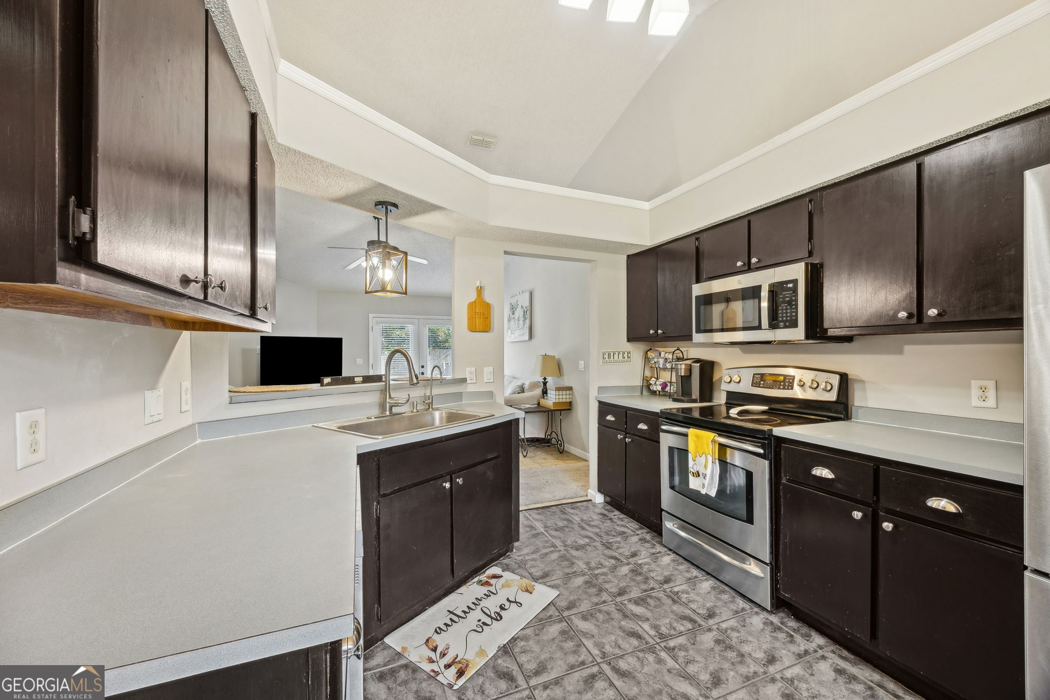 1720 Point Peter Road St. Marys, GA 31558 - Photo 23 of 93 a kitchen with stainless steel appliances granite countertop a sink a stove top oven a refrigerator with grey cabinets and wooden floor