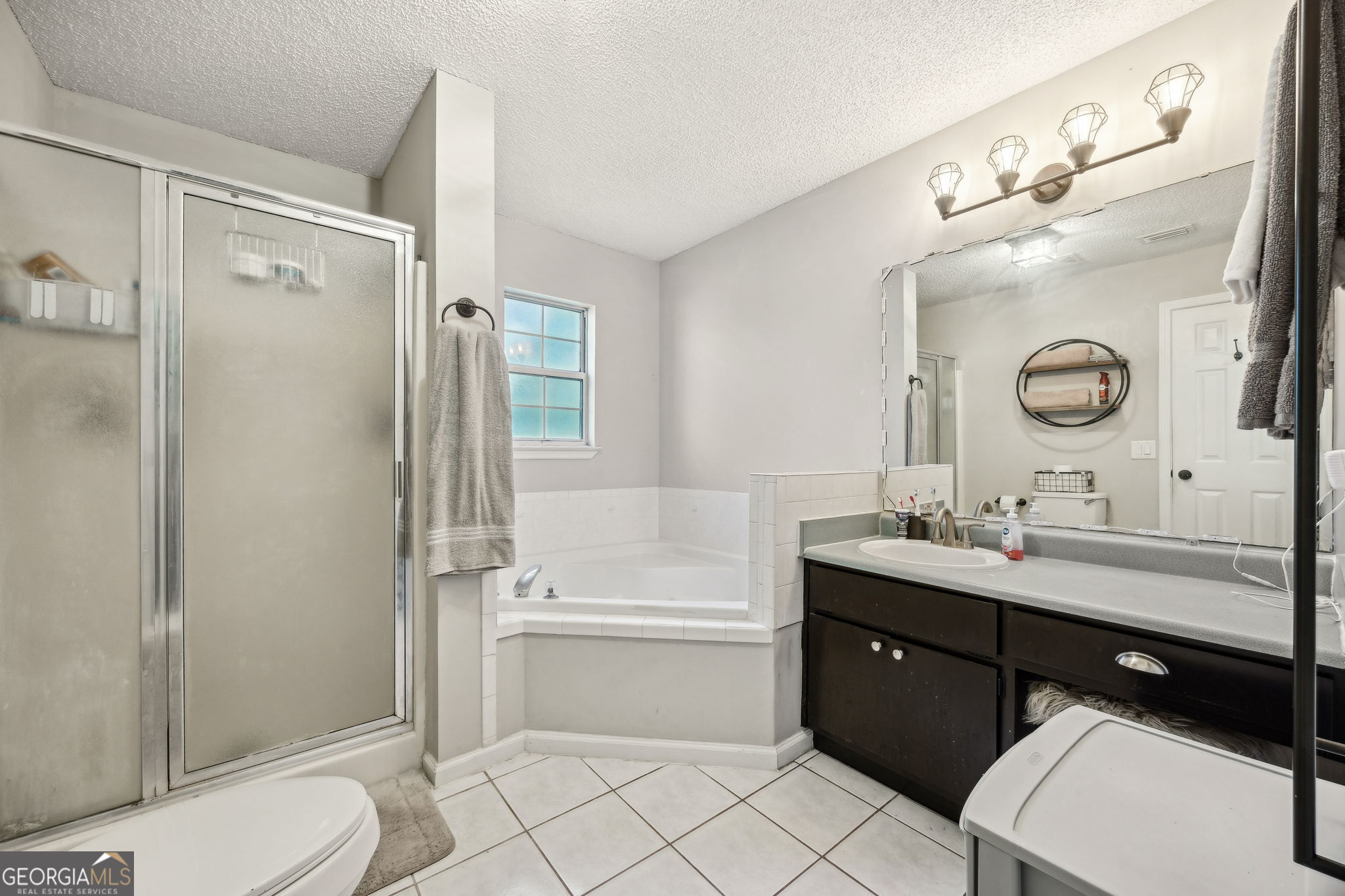 1720 Point Peter Road St. Marys, GA 31558 - Photo 30 of 93 a bathroom with a bathtub shower sink vanity mirror and toilet