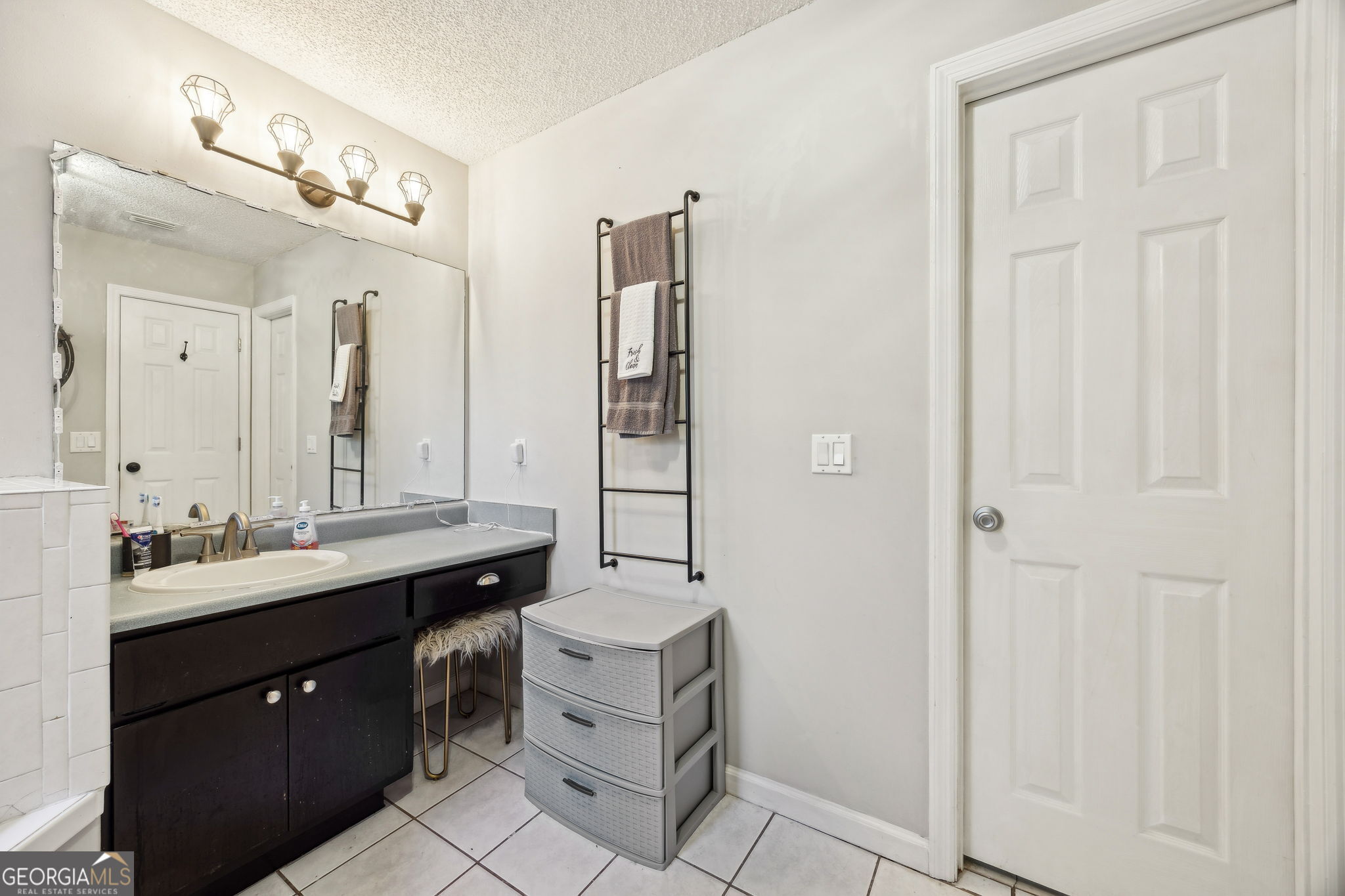 1720 Point Peter Road St. Marys, GA 31558 - Photo 33 of 93 a bathroom with a double vanity sink a mirror and a shower