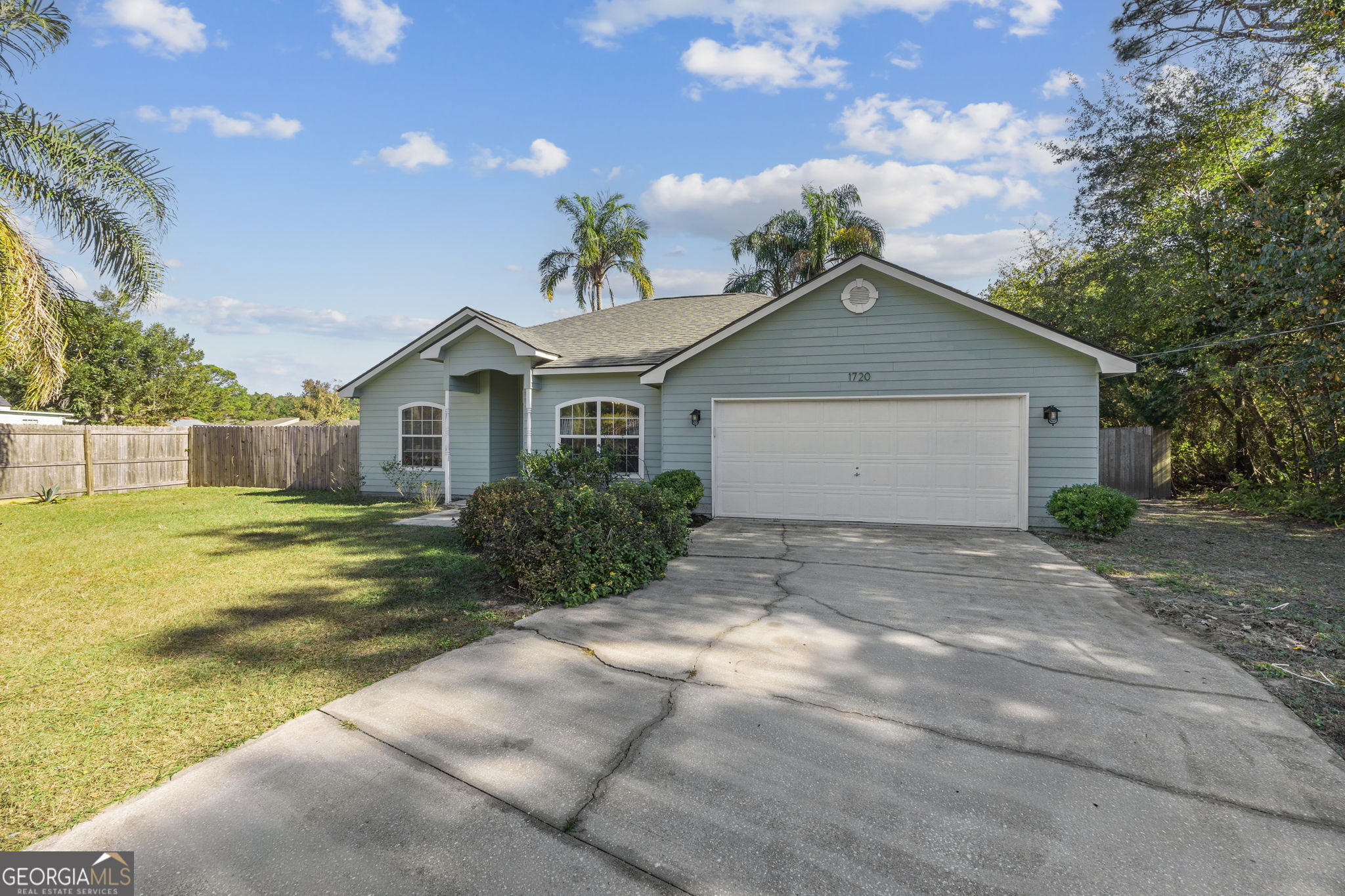 1720 Point Peter Road St. Marys, GA 31558 - Photo 7 of 93 a front view of a house with a yard and garage