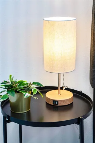 a white vase sitting on top of a shelf