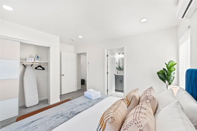 a bedroom with two beds and a large window