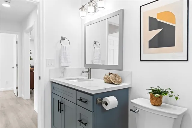 a kitchen with kitchen island granite countertop a sink a counter space appliances and cabinets