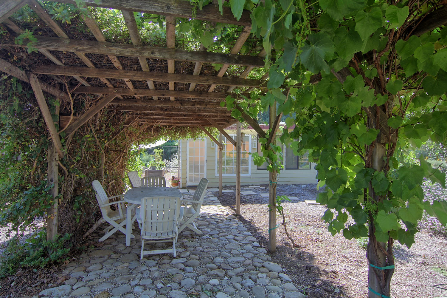 1442 South Rice Road Ojai, CA 93023 - Photo 38 of 50 a view of a chairs and table in backyard