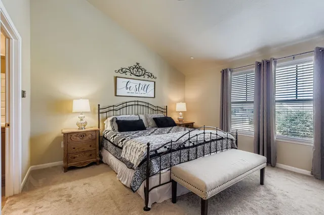 a bedroom with a bed and a table in it