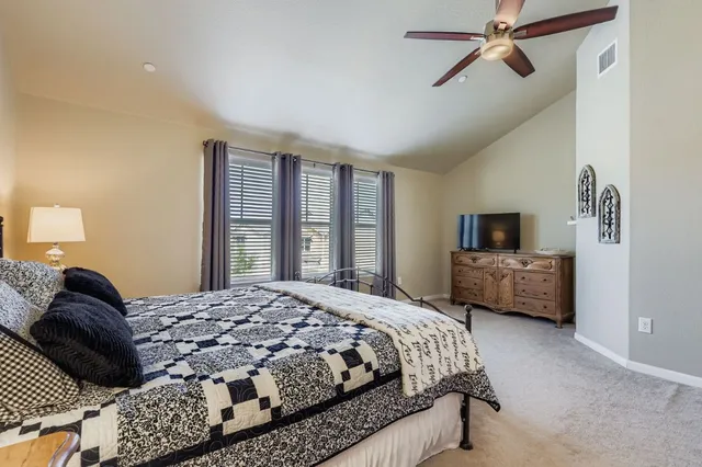 a bedroom with a large bed and a window