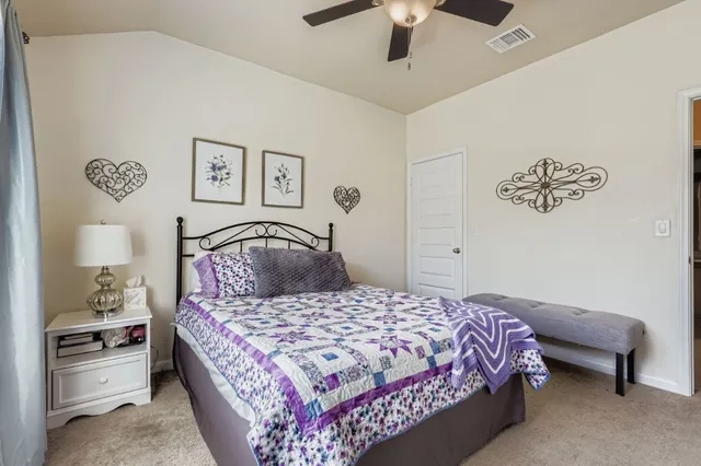 a bedroom with a large bed and a chandelier