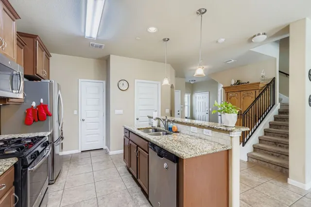 a kitchen that has a lot of cabinets in it