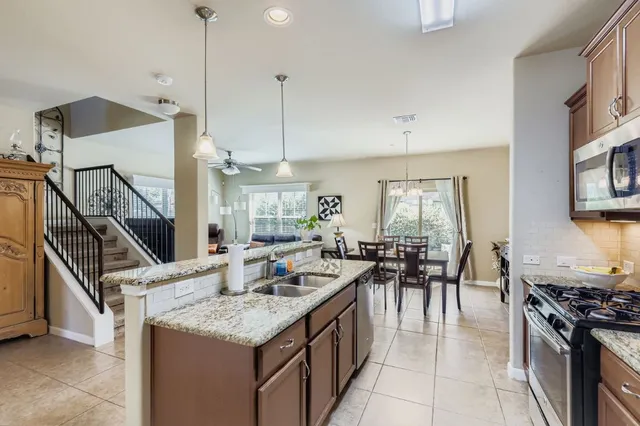 a kitchen with sink stove and cabinets