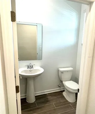 a white toilet sitting next to a bathroom sink
