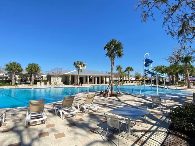 a view of a swimming pool with outdoor seating