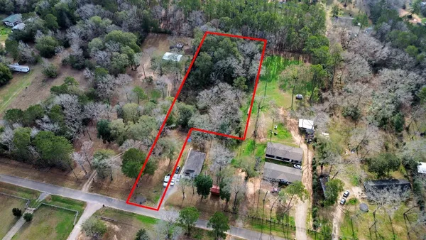 an aerial view of a houses with outdoor space
