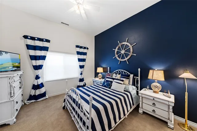 a bedroom with a bed and a chair