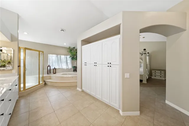 a balcony with furniture and a floor to ceiling window
