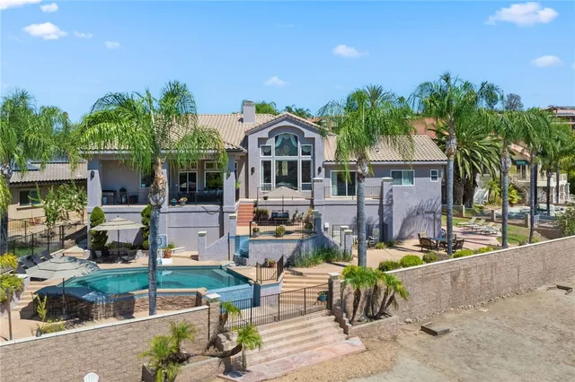 a spacious bedroom with a bed and a wooden floor