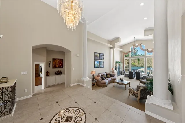 a living room with furniture a flat screen tv and a clock