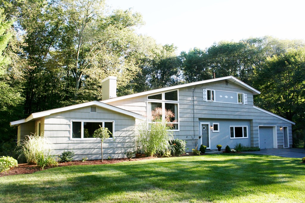 22 Long Meadow Road Chelmsford, MA 01824 - Photo 1 of 12 a front view of a house with a garden and trees