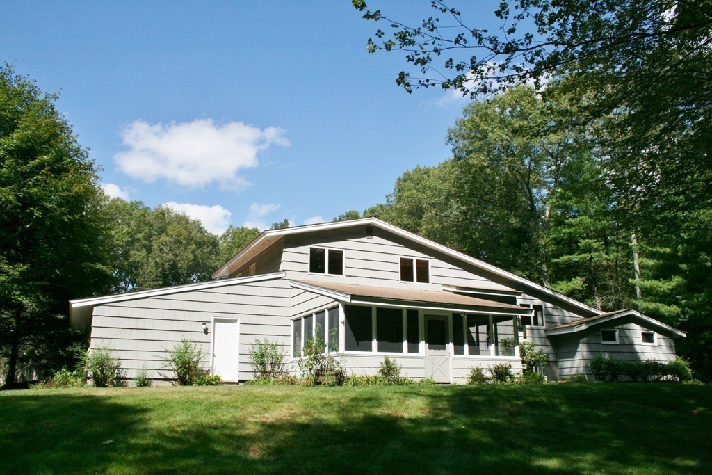 22 Long Meadow Road Chelmsford, MA 01824 - Photo 11 of 12 a white house with a small yard and wooden fence