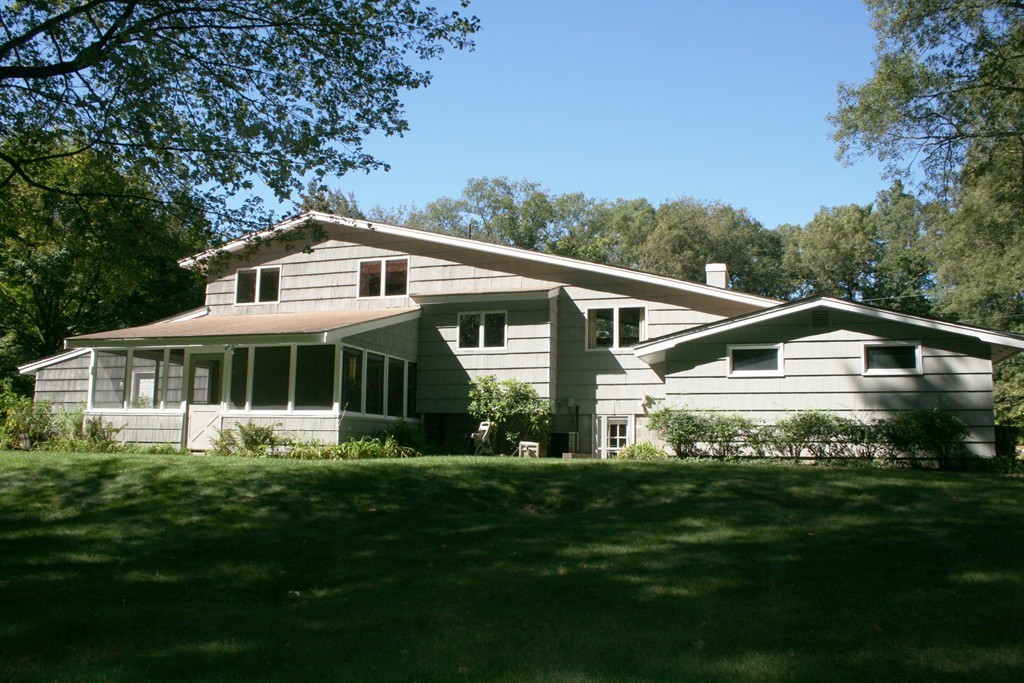 22 Long Meadow Road Chelmsford, MA 01824 - Photo 2 of 12 a front view of a house with a garden