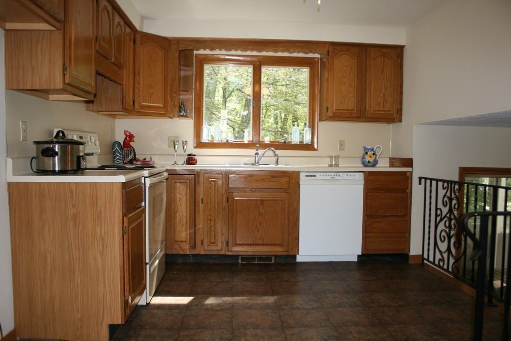 22 Long Meadow Road Chelmsford, MA 01824 - Photo 7 of 12 a kitchen with stainless steel appliances granite countertop a stove a sink dishwasher and a refrigerator