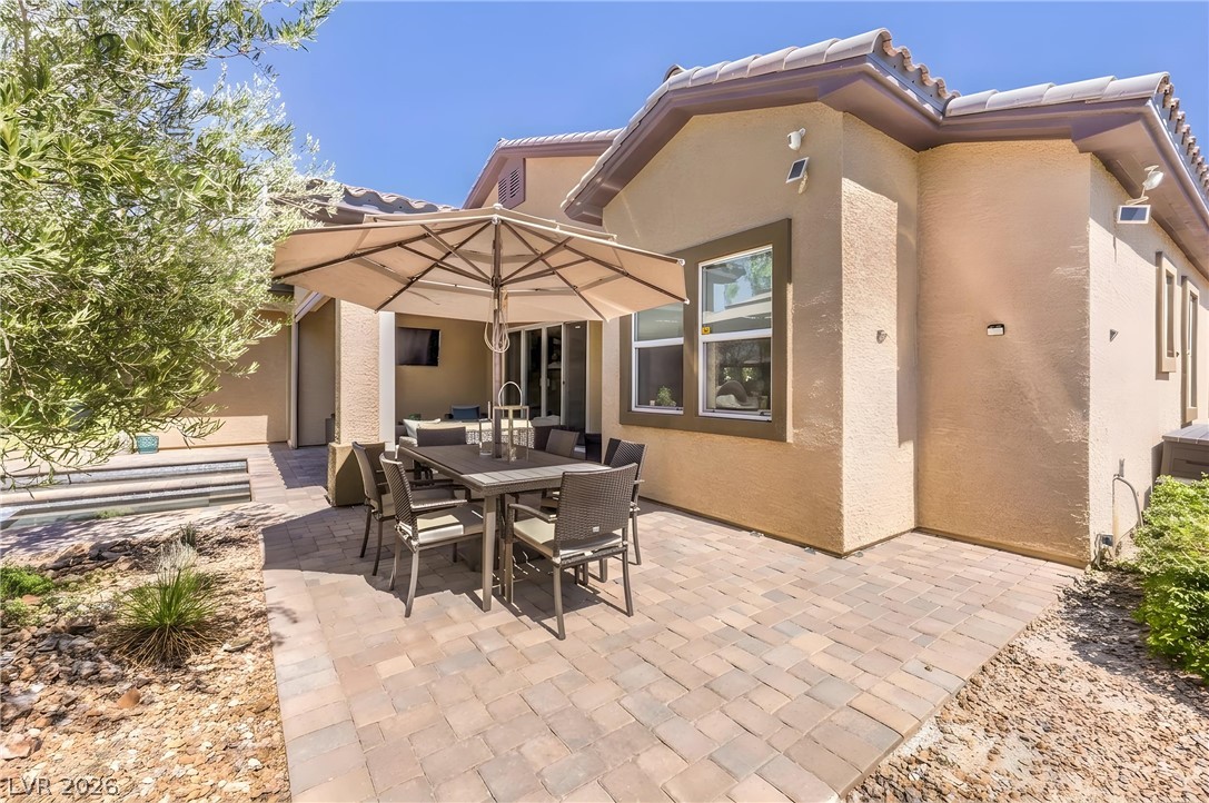 7119 Arabian Ridge Street Las Vegas, NV 89131 - Photo 54 of 73 An inviting outdoor patio, perfect for alfresco dining, extends from the home's sun-drenched exterior.