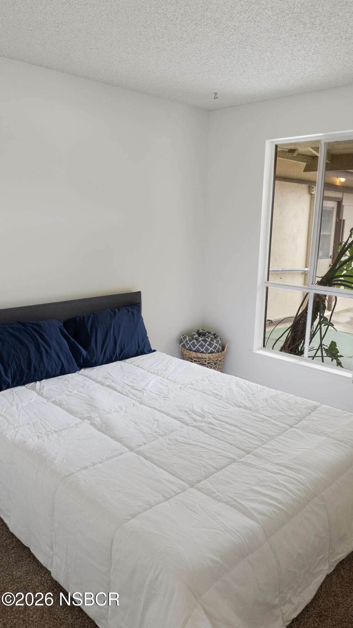 1312 North First Place Lompoc, CA 93436 - Photo 17 of 38 a bedroom with a bed and a mirror