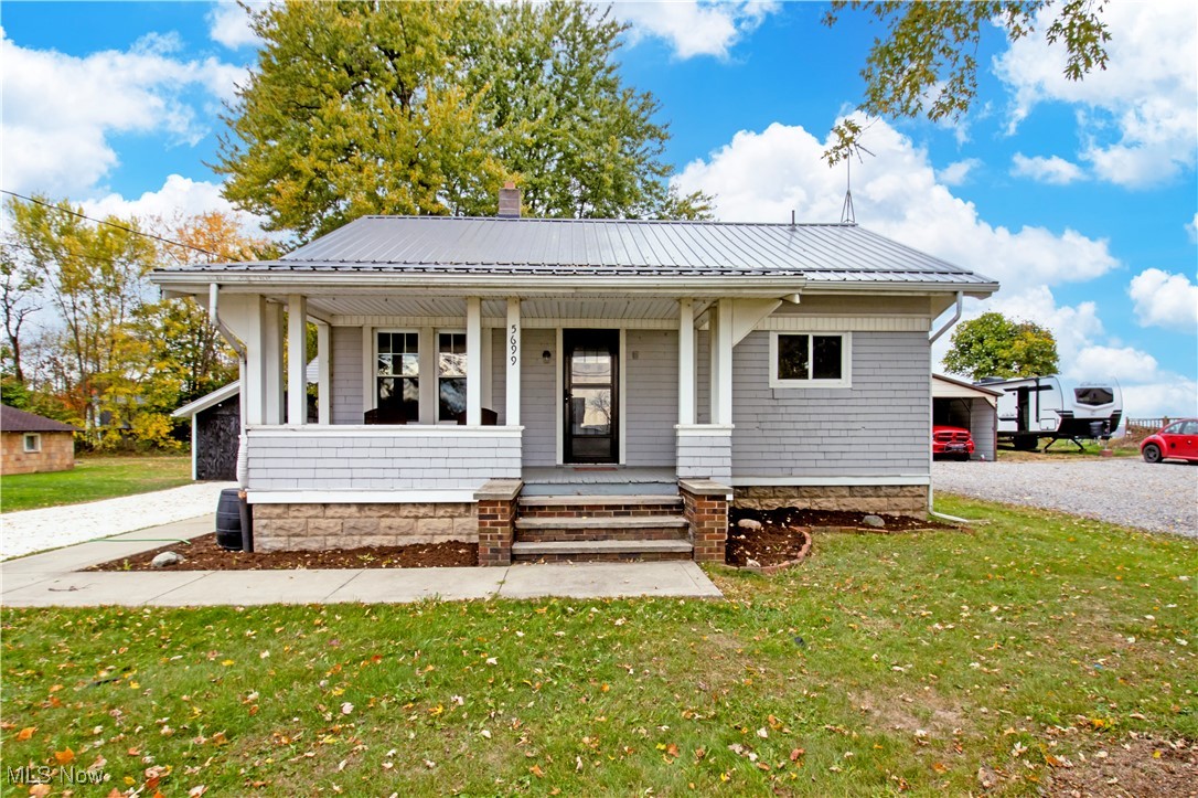 5699 Massillon Road Dalton, OH 44618 - Photo 1 of 24 Bungalow-style home with a front yard and a porch