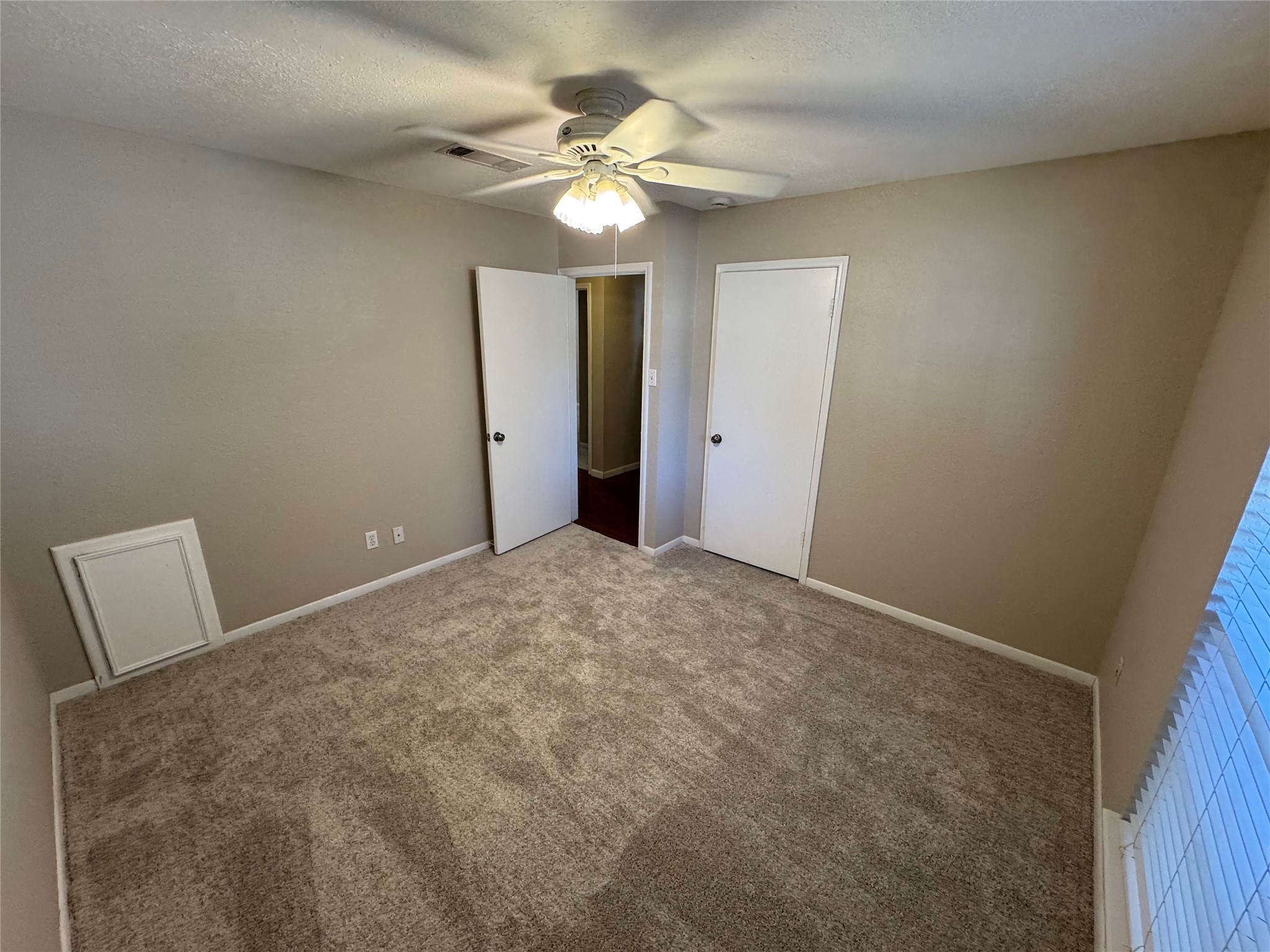 171 Bluebonnet Street Sugar Land, TX 77478 - Photo 18 of 28 a view of an empty room with a chandelier fan
