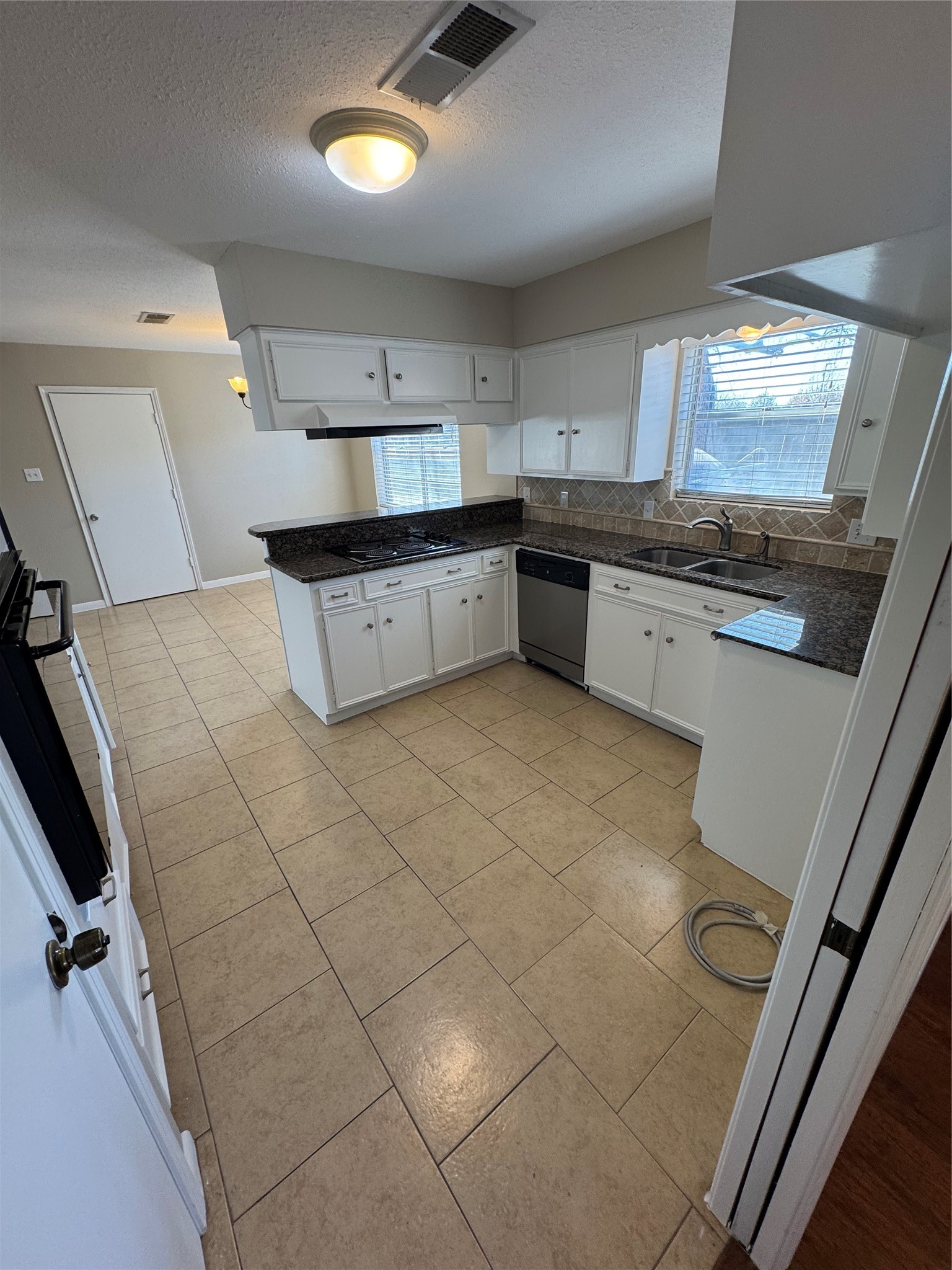 171 Bluebonnet Street Sugar Land, TX 77478 - Photo 8 of 28 a kitchen with stainless steel appliances a sink and a stove