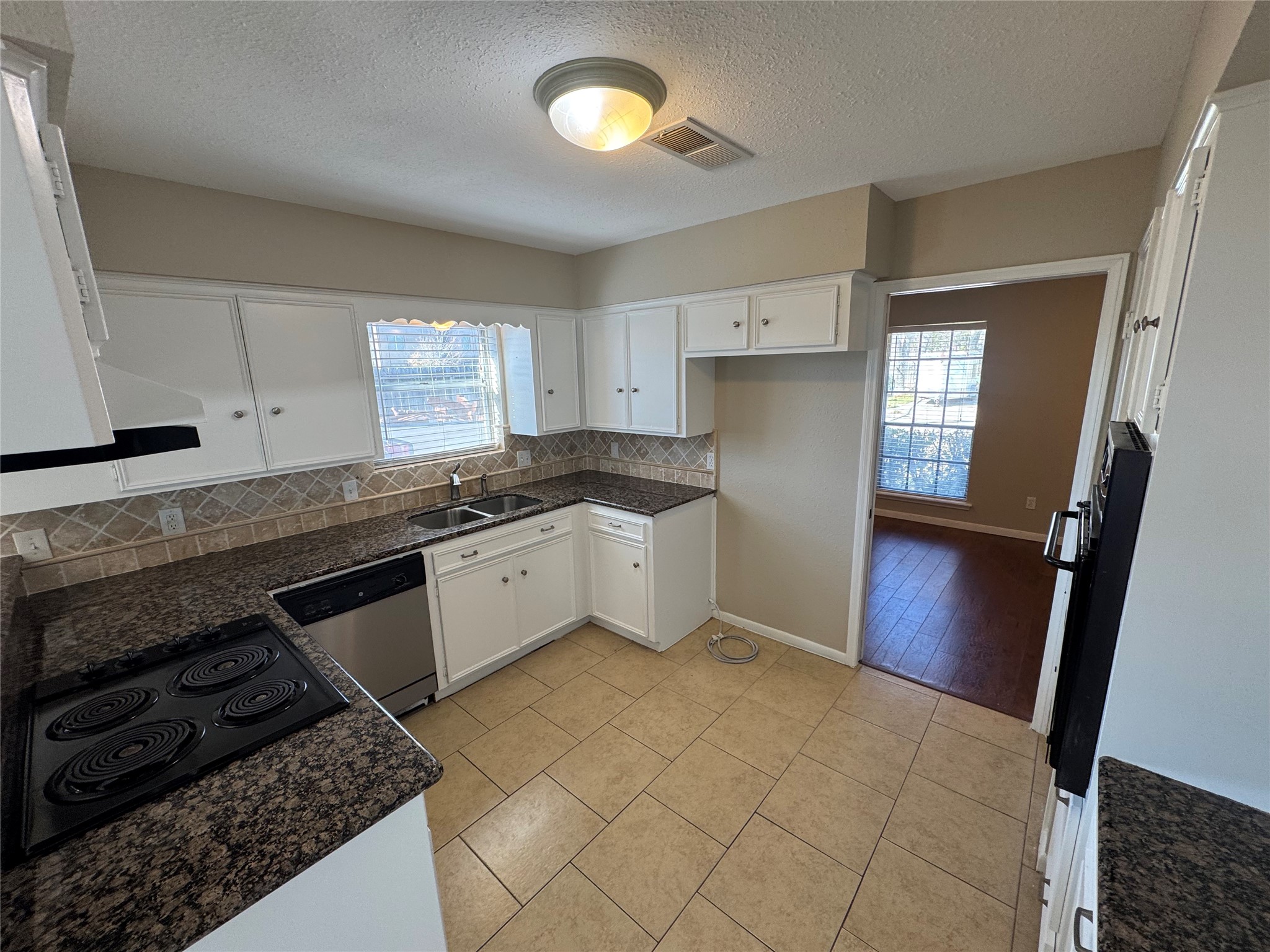 171 Bluebonnet Street Sugar Land, TX 77478 - Photo 9 of 28 a kitchen that has a sink a stove and cabinets