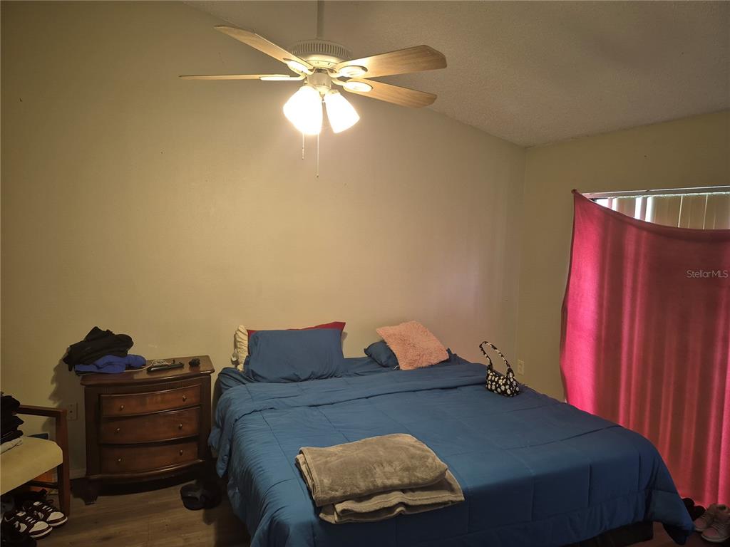 13710 Whitby Road Hudson, FL 34667 - Photo 6 of 21 a bedroom with a bed and a chandelier
