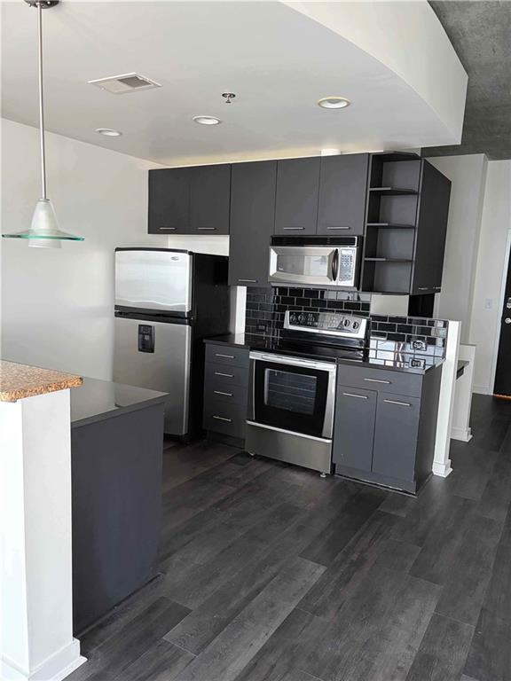 3324 Peachtree Road, Unit 2213 Atlanta, GA 30326 - Photo 2 of 28 a kitchen with kitchen island wooden floors appliances and cabinets