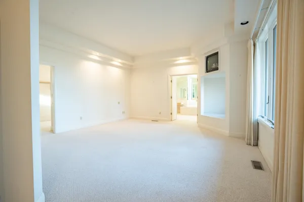 a view of an empty room and a window