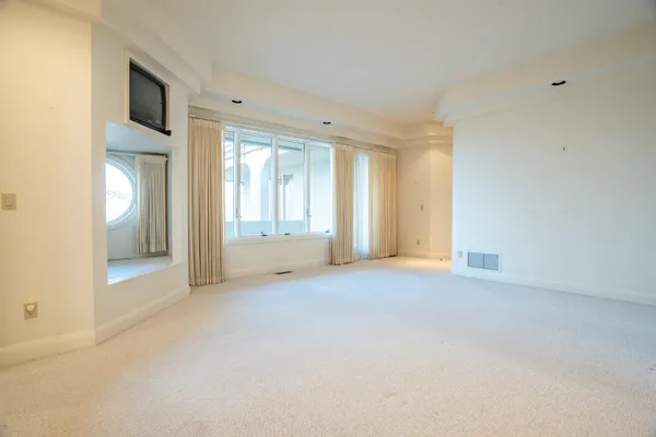 a view of an empty room with glass door