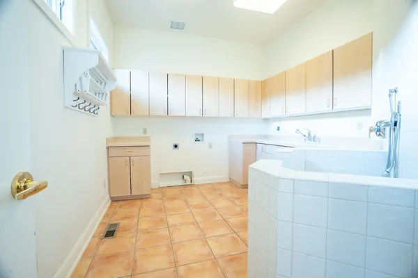 a kitchen with a sink a stove and cabinets