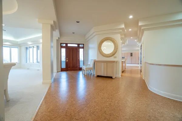 a view of a hallway with wooden floor and furniture